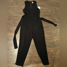 Black Jumpsuit With Front And Back Pockets And Waist Tie. Form Fitting And So Flattering Casual Black Jumpsuits And Rompers For Office, Casual Black Jumpsuit For Office, Black Spring Pantsuit For Date Night, Black Pantsuit For Spring Date Night, Black Pantsuit For Date Night In Spring, Black Jumpsuits And Rompers For Fall Workwear, Black Spring Pantsuit For Going Out, Black Pantsuit For Going Out In Spring, Black Jumpsuits And Rompers For Office In Fall