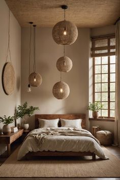 a bed sitting in a bedroom next to a window with hanging lights on it's sides