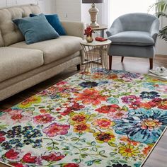 a living room filled with furniture and flowers on the rug