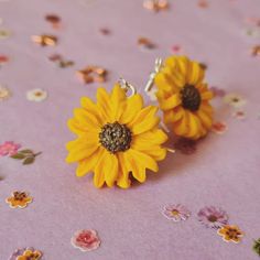 Sunflowers are big, bright, and iconic, a beautiful reminder of sunny summer days whatever the weather. Handmade from high-quality polymer clay, these earrings are lightweight and a perfect accessory to brighten up your outfit and day. International customers: Please be advised that additional customs charges may be applied upon entry and these charges are your responsibility to pay. I have no knowledge of if, when, or how much any of these charges may be. Promise Necklace, Recycling Sorting, Mermaid Pendant, Recycling Containers, Sunflower Earrings, Mermaid Necklace, Gift Decorations, Summer Days, Jewelry Earrings Dangle