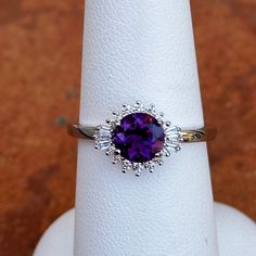 14KT white gold round, faceted amethyst and baguette and round diamond ballerina design ring. Size 6.5 (1) Genuine Round Faceted Amethyst Measures approx. 6.5mm Faceted Round and Tapered Baguette Ring Weighs 2.90 Grams 1/6 carat total weight SI2/3 clarity GHI color Prongs-set; One on each side Elegant White Gold Amethyst Ring With Cubic Zirconia, Elegant White Gold Amethyst Ring With Round Cut, Purple Cubic Zirconia Jewelry With Brilliant Cut, Purple Brilliant Cut Cubic Zirconia Jewelry, Purple Round Cut Amethyst Ring, White Gold Amethyst Ring With Brilliant Cut, Brilliant Cut Amethyst Ring In White Gold, Amethyst Ring With Brilliant Cut Cubic Zirconia, White Gold Brilliant Cut Amethyst Ring