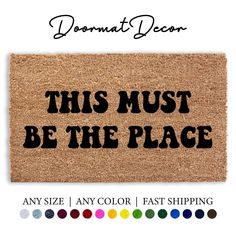 this must be the place door mat with black lettering on it and colors to choose from