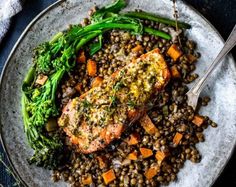 salmon and lentils on a plate with broccoli, asparagus and carrots