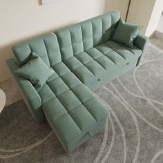 a green couch sitting on top of a carpeted floor