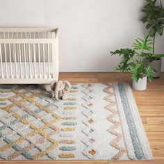 a baby crib and rug in a room