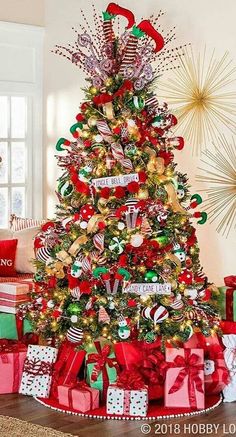 a decorated christmas tree with presents under it