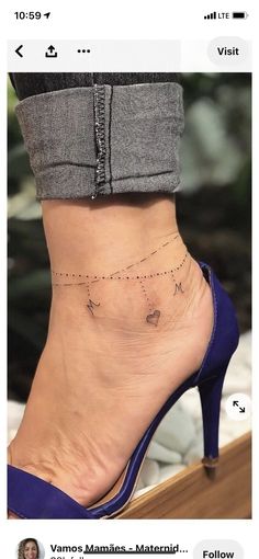 a woman's foot with a small tattoo on the side of her ankle and an arrow