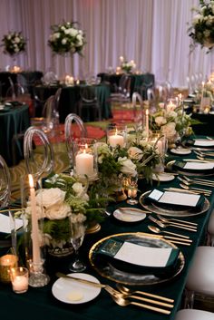 a long table is set with place settings and candles