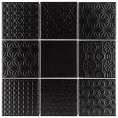 black square tiles are arranged in the shape of an intricate pattern on a white background