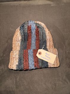 "Beautiful crochet ribbed beanie to keep you warm in the winter months or add some flare to your outfit!  *Shown is Unisex Adult Medium in \"Lakefront\"  color* Sizing:  Unisex small adult: 21-22 inch head circumference  Unisex medium adult: 22-23 inch head circumference  Unisex large adult: 23-24 inch head circumference  These beanies are stretchy due to the ribbed pattern.  Caring for your beanie:  Hand washing is preferred but beanie can be placed in a delicate garment bag and on delicate cyc Handmade Casual Beanie As Gift, Warm Crochet Yarn Hat For Gift, Warm Yarn Crochet Hat As A Gift, Yarn Crochet Hat For Gift, Handmade Brown Casual Beanie, Warm Crochet Yarn Hat As Gift, One Size Crochet Yarn Hat As A Gift, Handmade Casual Brown Beanie, Crochet Yarn Hat As Gift