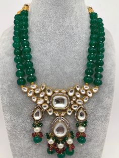 Kundan AD Pendent with Green Beads Necklace with Matching EarringsColor : GoldenSize : Necklace Length : 16 Inches; Earring Length : 2.75 InchesStones : Kundan AD Green Beads Pearls Traditional Green Teardrop Necklace, Spiritual Green Jewelry With Dangling Beads, Green Spiritual Jewelry With Dangling Beads, Traditional Beads With Stones For Jewelry Making, Traditional Green Beaded Necklaces With Stones, Traditional Green Beaded Necklace With Stones, Festive Round Beads Necklace With Stones, Festive Round Bead Stone Necklaces, Festive Beaded Necklaces With Round Stones