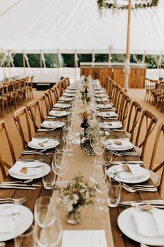 a long table set with plates and wine glasses