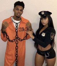 a man and woman dressed up in jail clothes standing next to each other with handcuffs on their hands