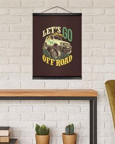 a sign that says let's go off road hanging on a wall next to some potted plants