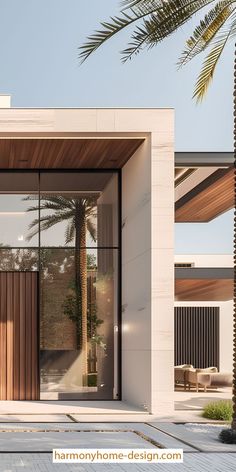 an entrance to a modern home with palm trees