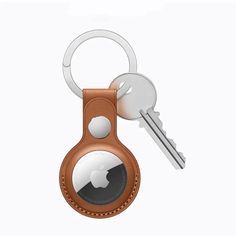 an apple keychain with a leather case and two keys attached to each other