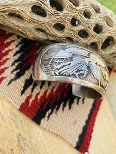 Pre-owned LOT : No ETHNIC & REGIONAL STYLE : Native American JEWELRY TYPE : Bracelets TYPE : Bracelet STYLE : Cuff MATERIAL : Sterling Silver FEATURED REFINEMENTS : Navajo Jewelry METAL : Sterling Silver MAIN STONE : No Stone Beautiful Vintage Navajo Hand Stamped Sterling Silver Story Teller Cuff Bracelet. Such a gorgeous design on this cuff! One of a kind piece. Cuff measures just over 1 1/4 inches wide. Inside circumference is 5 1/4 inches with a 1 1/2 inch gap. Signed by the artist and st Southwestern Style Bracelet With Polished Finish, Southwestern Style Polished Bangle, Silver Southwestern Style Cuff Bracelet For Formal Occasions, Southwestern Style Jewelry With Polished Finish For Anniversary, Southwestern Style Polished Jewelry For Anniversary, Southwestern Style Round Cuff Bracelet As Gift, Sterling Silver Cuff Jewelry, Unique Polished Cuff Jewelry, Formal Stamped Cuff Jewelry