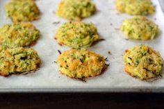 there are many small food items on the baking sheet in the pan, including broccoli florets