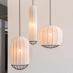 three lights hanging from the ceiling in a room