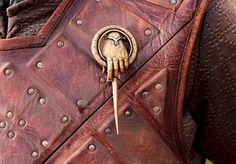 a close up of a person wearing a leather jacket with the words talk to the hand on it