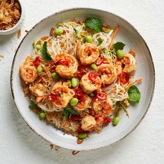 a white bowl filled with noodles and shrimp