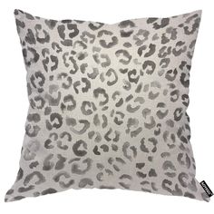 a grey and white leopard print pillow on a white background