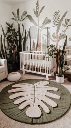 a baby's room with a white crib and green plants on the wall