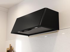 a black stove hood mounted on the side of a wall