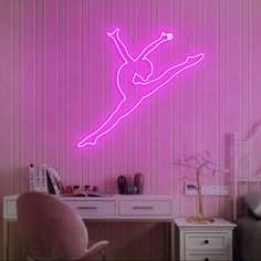 a pink neon sign in the shape of a female figure