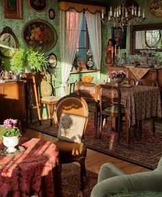 a living room filled with furniture next to a dining room table and chairs in front of a window