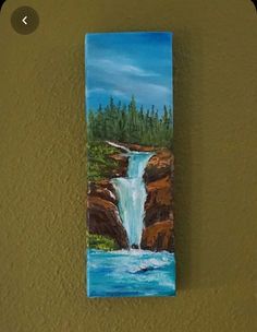 a painting on the wall of a waterfall with trees in the background and water running down it