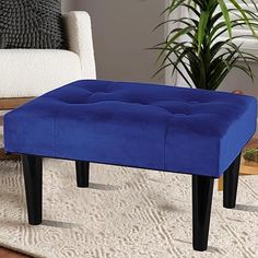 a blue foot stool sitting on top of a rug