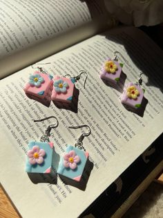 Introducing our charming colorful Book with a cute flower Earrings! 📚🌸 Unbox the joy of literary style with our delightful earrings, shipped in a packaging reminiscent of a miniature book, complete with a sweet flower accent on the front cover. These earrings are the perfect fusion of elegance and simplicity, designed for book lovers who appreciate the finer things in life. Crafted with meticulous attention to detail, these earrings boast a super cute and lightweight design, ensuring comfort for all-day wear. Available in three enchanting colors, they effortlessly complement any outfit, making them a versatile and must-have accessory for every book enthusiast. Experience the magic of literary-inspired fashion with our Book-Lover's Earrings. Add a touch of whimsy to your ensemble and cele Diy Book Earrings, Clay Bookshelf Earrings, Tiny Book Earrings Diy, Bookshelf Polymer Clay Earrings, Book And Flowers, Book Lovers Book, Gifts For Book Lovers, Book Earrings, Earrings Acrylic