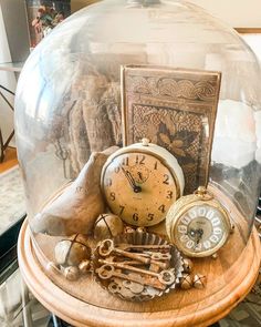 there is an old clock under a glass dome