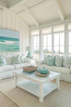 a living room filled with white furniture and lots of windows