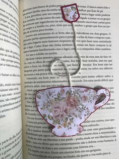 the book is open to show an image of a teacup with flowers on it