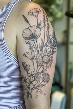 a woman with a flower tattoo on her arm