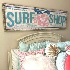 there is a surf shop sign above the bed