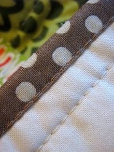 closeup of the stitching on an upholstered piece of fabric that has been sewn