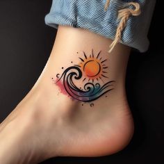 a woman's foot with a colorful sun and wave tattoo on her left side