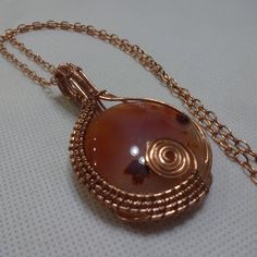 Breathtaking "Carnelian" Wire Wrapped Handmade Copper Pendant On A 18" Chain #749a All Of My Jewelry Is Handmade By Me In My Smoke & Pet Free Home!!!!!! Please Note That Every Item Purchased Comes In A Drawstring Organza Bag For Easy Gift Giving!!! Please Note That I Will Consider Any Reasonable Offer On My Jewelry!!!!!!!!!! Please Let Me Know If You Have Any Further Questions. Thanks For Stopping By And Have A Terrific Day!!!! Hand Wrapped Gold Agate Necklaces, Hand Wrapped Gold Agate Necklace, Wire Wrapped Round Agate Jewelry, Hand Wrapped Carnelian Pendant Jewelry, Hand Wrapped Agate Jewelry Gift, Hand Wrapped Agate Jewelry For Gifts, Artisan Handmade Spiral Necklace, Carnelian Wire Wrapped Jewelry As A Gift, Hand Wrapped Carnelian Pendant Necklace