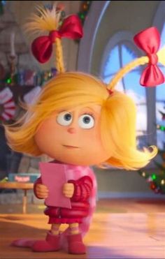 a cartoon character with blonde hair holding a piece of paper in front of a christmas tree