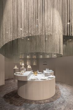 an elegant dining room with chandelier hanging from the ceiling