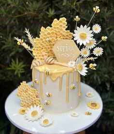 a cake decorated with honeycombs and daisies