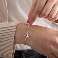 Introducing our exquisite Sterling Silver Starfish Bracelet, a perfect accessory for ocean lovers, scuba divers, and beach enthusiasts.  This listing offers the option to personalize your bracelet with a hand-stamped initial disc, making it even more special. Crafted with meticulous attention to detail, this bracelet features a stunning starfish charm and a delicate chain, both made from high-quality sterling silver. The sterling silver composition ensures durability and a timeless shine. Measur Adjustable Silver Charm Bracelet With Starfish, Elegant Starfish Bracelet For Gift, Adjustable Starfish Bracelet With Lobster Clasp, Silver Strand Bracelets As Gift, Adjustable Star-shaped Jewelry With Starfish Charm, Adjustable Starfish Charm Jewelry, Ocean-inspired Starfish Bracelets As Gifts, Starfish Charm Bracelet As A Gift, Starfish Charm Bracelet Gift