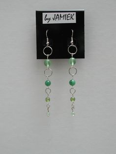 Earrings Green Beads Ring Chain Dangle in Silver Tone or Gold Tone by rrdesigns561 on Etsy Trendy Green Dangle Jewelry, Trendy Wire Wrapped Drop Earrings, Green Beaded Chain Earrings With Round Beads, Green Earrings With Beaded Chain And Round Beads, Green Wire Wrapped Jewelry For Party, Czech Glass Dangle Jewelry For Party, Nickel-free Green Beaded Earrings For Parties, Trendy Adjustable Jewelry With Dangling Beads, Trendy Wire Wrapped Dangle Earrings