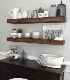 two wooden shelves with dishes and cups on them