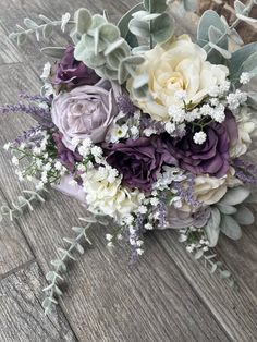 a bridal bouquet with purple and white flowers