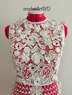 a red dress with white lace and flowers on it