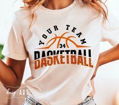 a woman wearing a t - shirt that says your team basketball